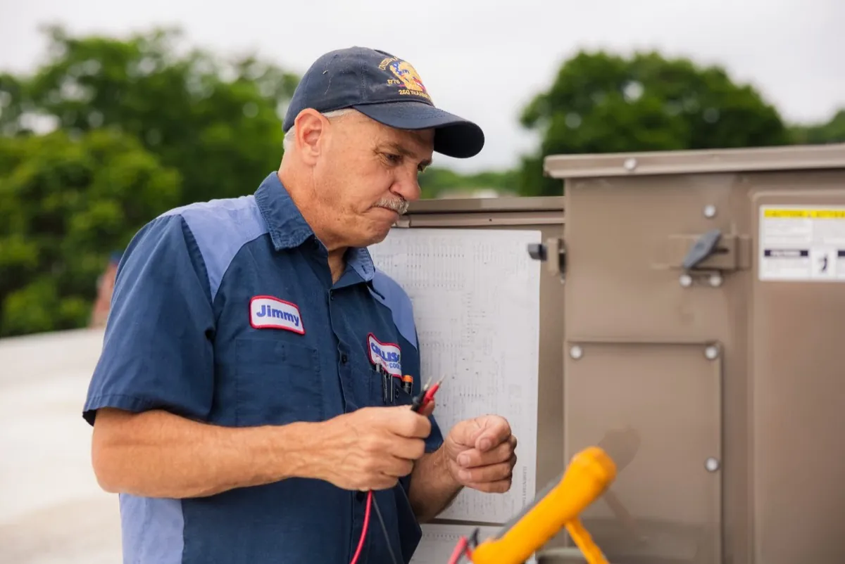 Callison technician Jimmy reading a wiring diagram while diagnosing a heating system in Staunton, Virginia