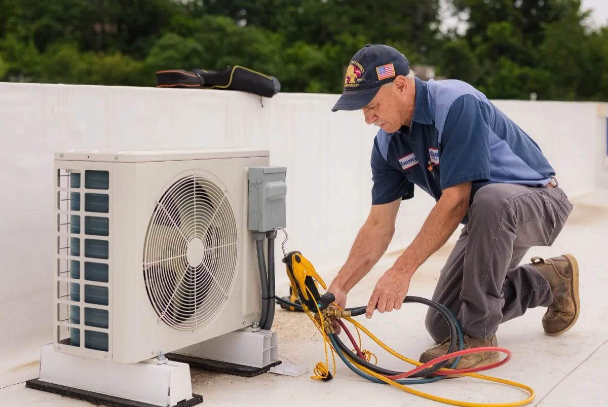 Callison technician charging a ductless mini-split air conditioning system on a rooftop in Staunton, Virginia
