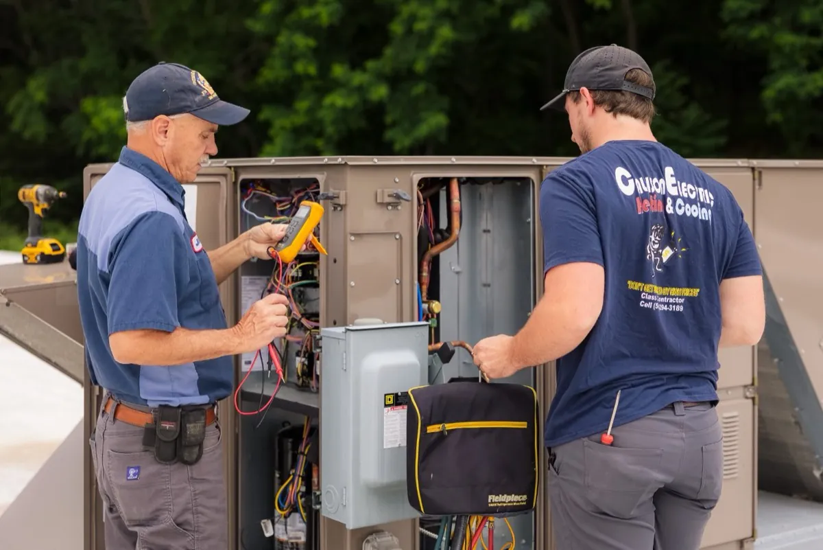 Callison HVAC technicians servicing a rooftop unit together in Staunton, Virginia