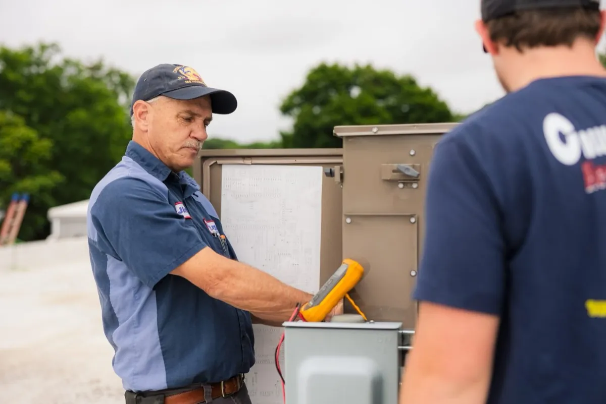 Callison electrician testing a commercial control panel with a meter in Staunton, Virginia